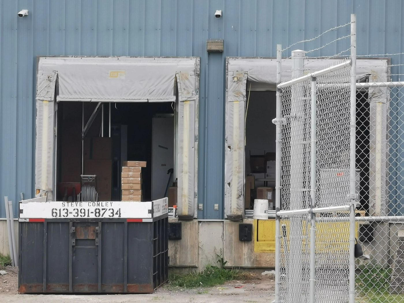Steve's Bins roll-off container at a commercial loading dock